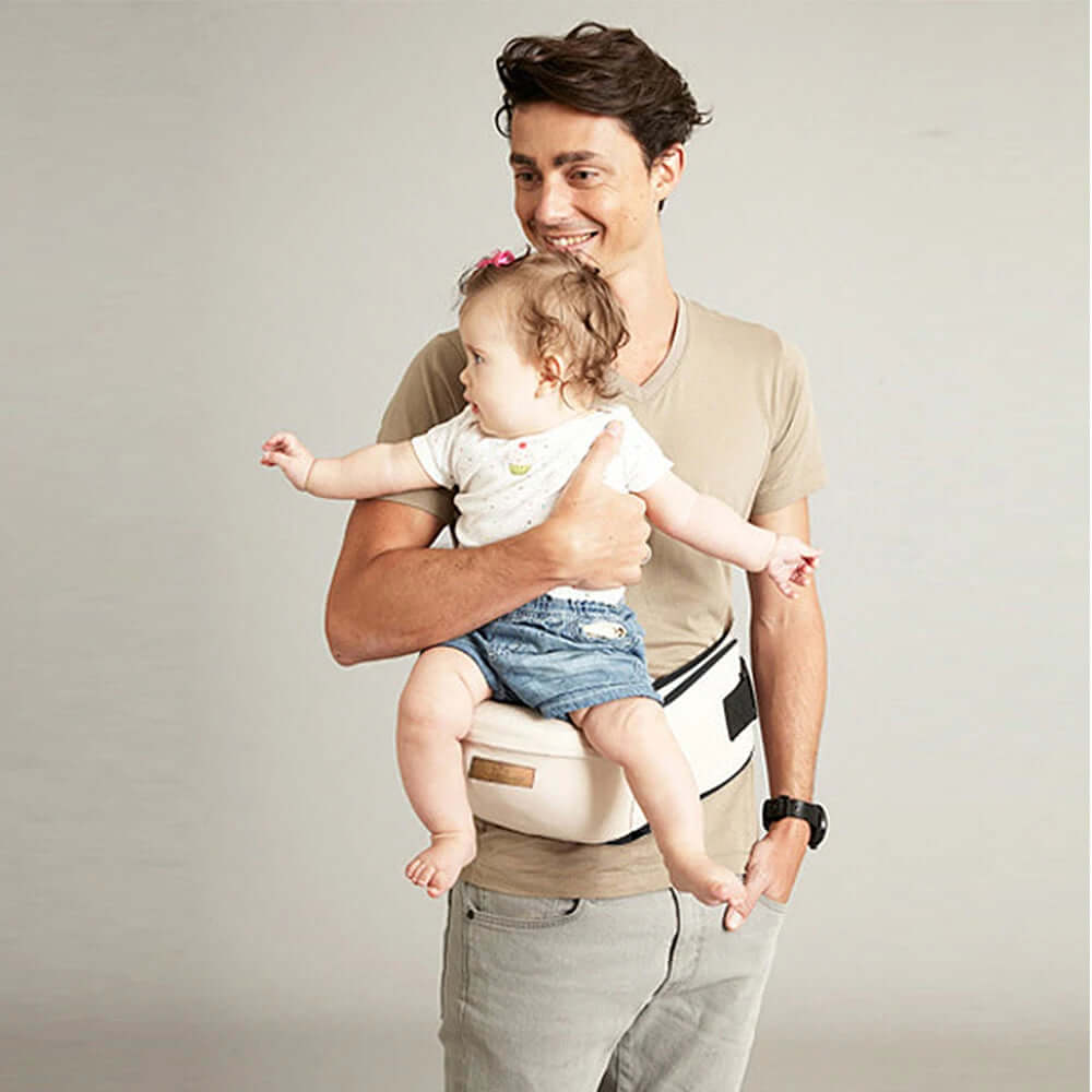 Parent using Clariom ergonomic baby waist carrier with baby in forward-facing position for comfort and support.